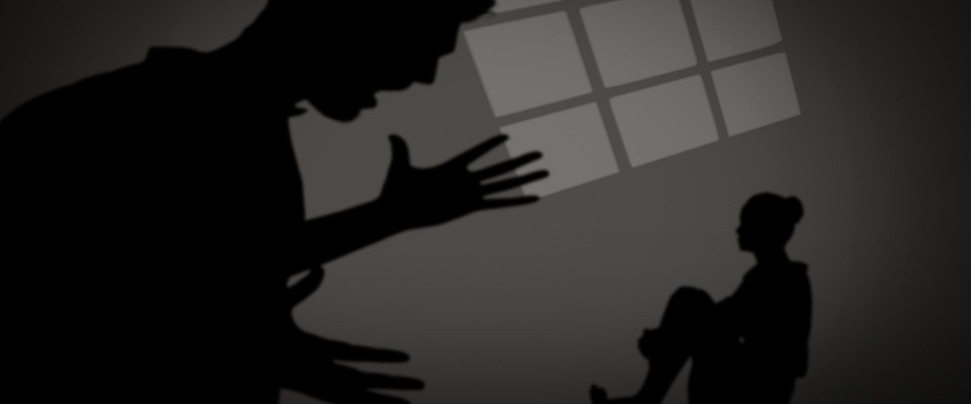 Businesswoman sitting on floor against silhouette of man shouting Businesswoman sitting on floor against silhouette of man shouting