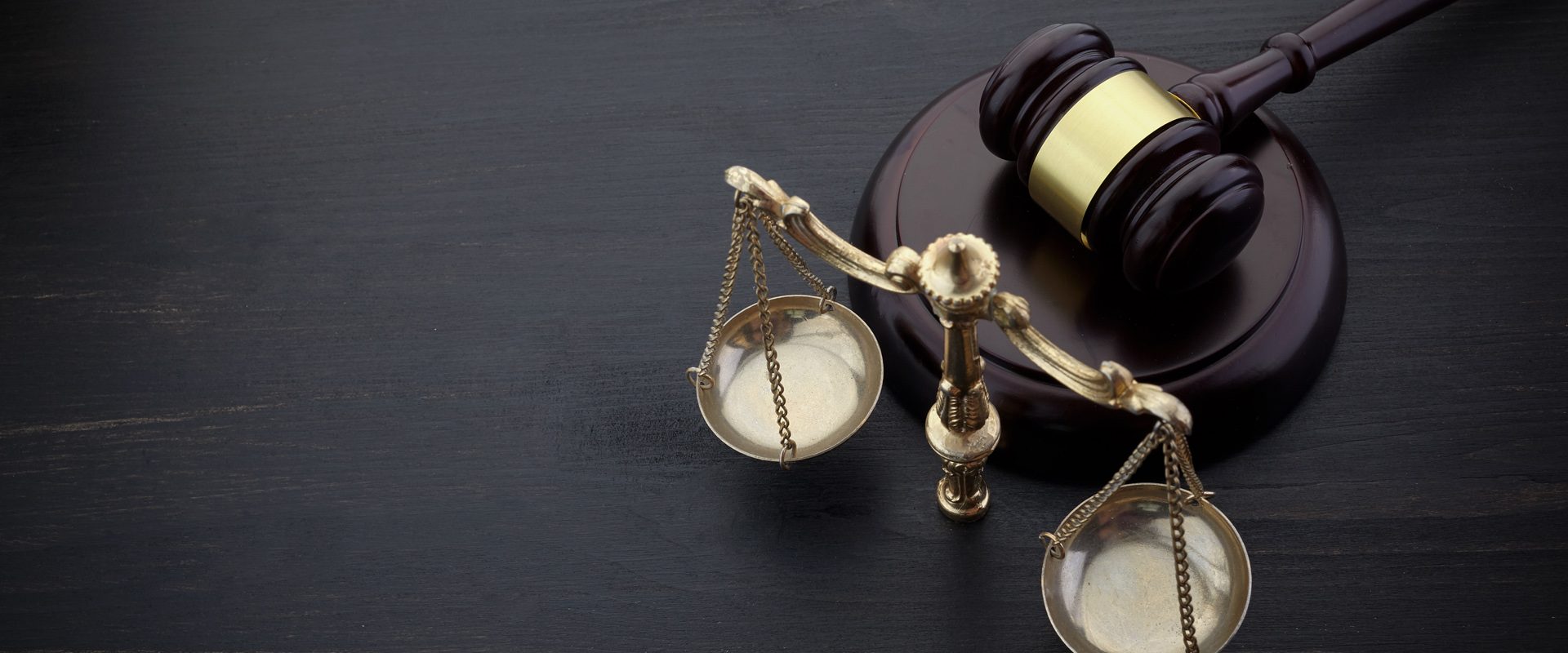 Judges Gavel And Scale Of Justice On The Black Table Background. Law Concept. Judges Gavel And Scale Of Justice On The Black Background. Law Concept.